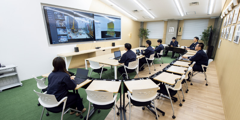 図版:スマート工事事務所は8連大型モニタと遠隔会議システムを備え,各種会議や遠隔製品検査など柔軟に対応できる
